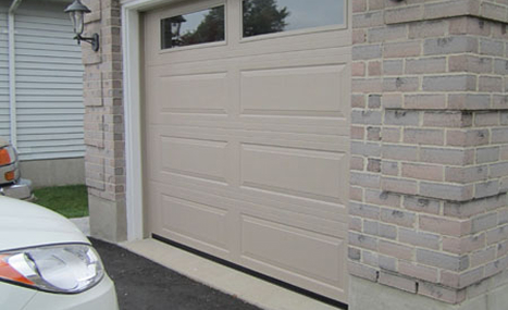brick house with beige garage door
