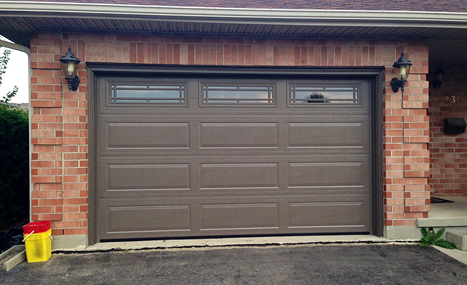 brick house with brown garage door