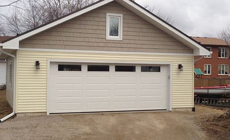 siding shop with beige garage door