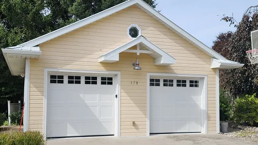 beige garage with white garage doors